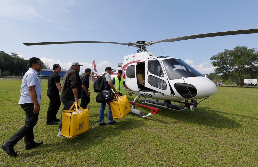 EC personnel board a American Eurocopter AS350B3 aircraft to Redang island May 8, 2018. u00e2u20acu201d Bernama pic