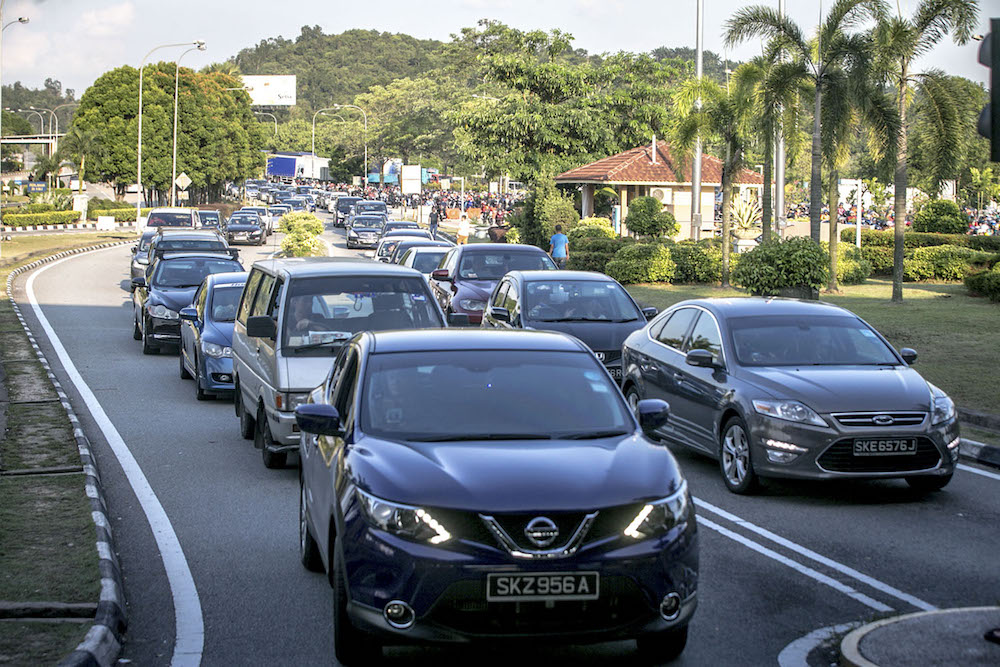 Vehicles wait to enter the Johor side of the Sultan Abu Bakar Complex, which crosses the Johor Strait, ahead of polling day, in Johor Baru May 8, 2018. u00e2u20acu201d Picture by Hari Anggara