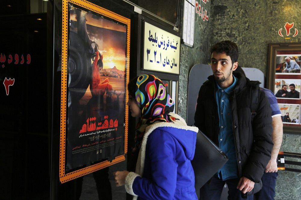 Iranians buy tickets for the film u00e2u20acu02dcBe Vaght-e Chamu00e2u20acu2122 (u00e2u20acu02dcDamascus Timeu00e2u20acu2122) by Iranian director Ebrahim Hatamikia at a cinema in Tehran May 1, 2018. u00e2u20acu201d AFP pic