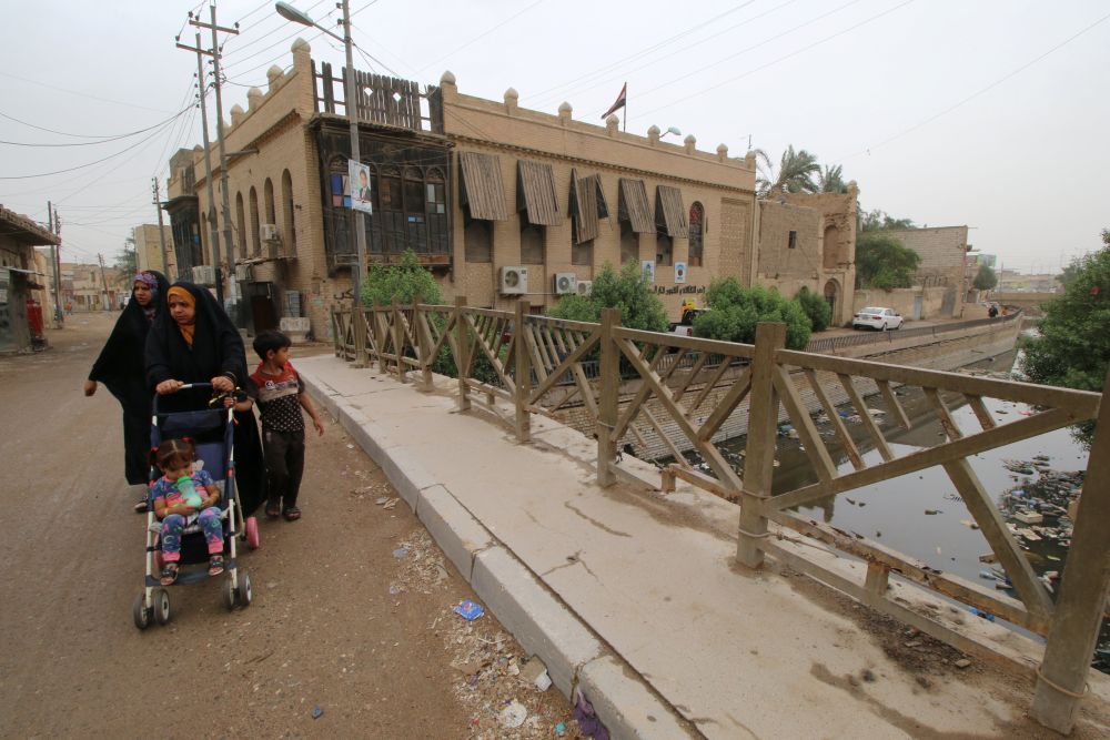 People walk near one of the ancient historic houses dated back to the time of Ottomans in the old downtown of Basra, Iraq May 9, 2018. u00e2u20acu2022 Reuters pic