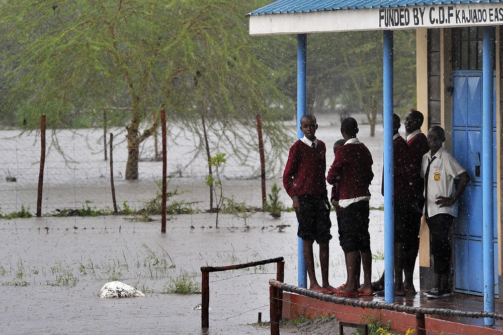 Kenyan school children gather on a veranda outside their classroom at Isinya Secondary School at Isinya some 58km south-east of Nairobi on March 15, 2018, after classes were stopped due to flash floods in the school compound. u00e2u20acu201d AFP pic