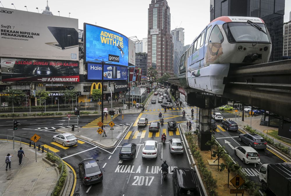 A KL Monorail train travels past Bukit Bintang. u00e2u20acu2022 Picture by Firdaus Latif