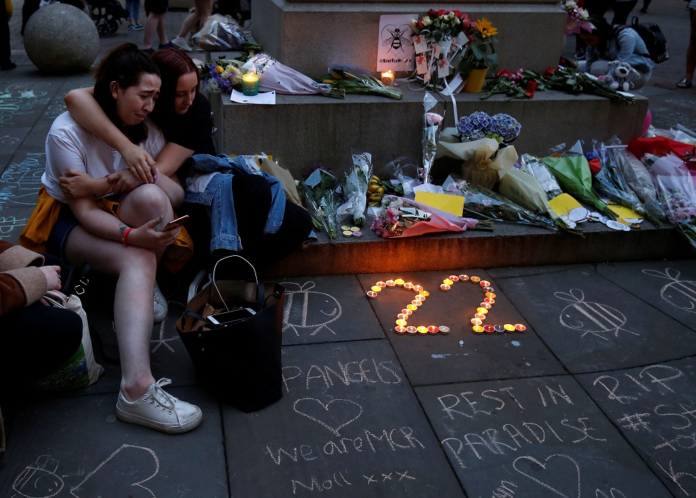 Girls sit by a memorial during the first anniversary of the Manchester Arena bombing, in Manchester, Britain, May 22, 2018. u00e2u20acu201d Reuters pic