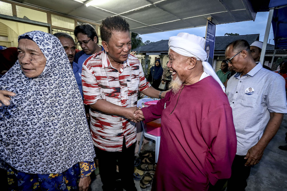 Barisan Nasional (BN) Kukup state seat candidate, Datuk Md Othman Yusof, meets residents on his campaign trail in Pontian May 7, 2018.