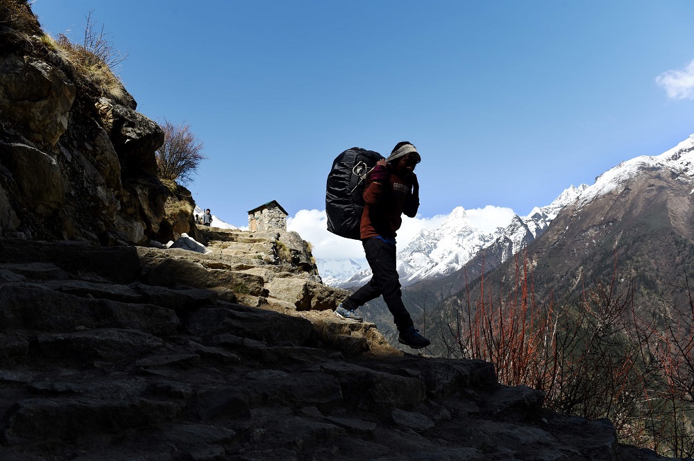 In this file photograph taken on April 19, 2015, a Nepalese porter carries merchandise through a valley near Pangboche in the Khumbu region in north-east Nepal. u00e2u20acu201d AFP pic