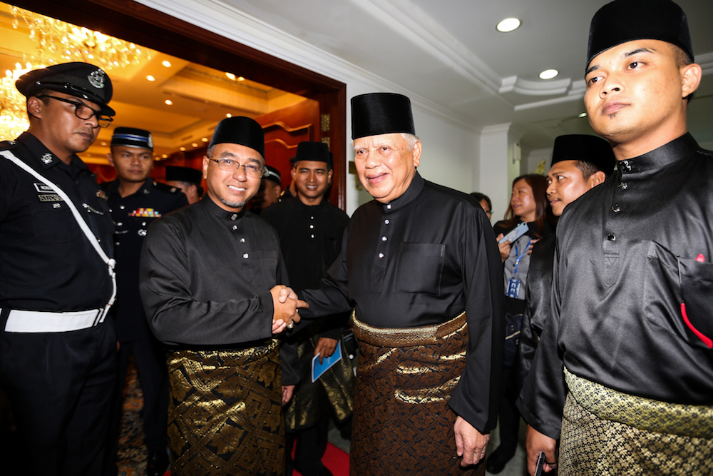 Newly appointed Melaka Chief Minister Adly Zahari shakes hand with Yang Di-Pertua Negeri Melaka Tun Mohd Khalil Yaakob in Melaka May 11, 2018. u00e2u20acu201d Picture by Ahmad Zamzahuri