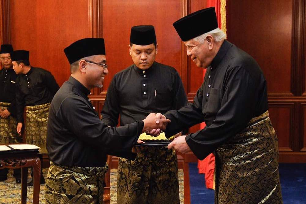 Adly Zahari receives his letter of the appointment as Melakau00e2u20acu2122s 11th Chief Minister from Yang Di-Pertua Melaka Tun Mohd Khalil Yaakob in Melaka May 11, 2018.