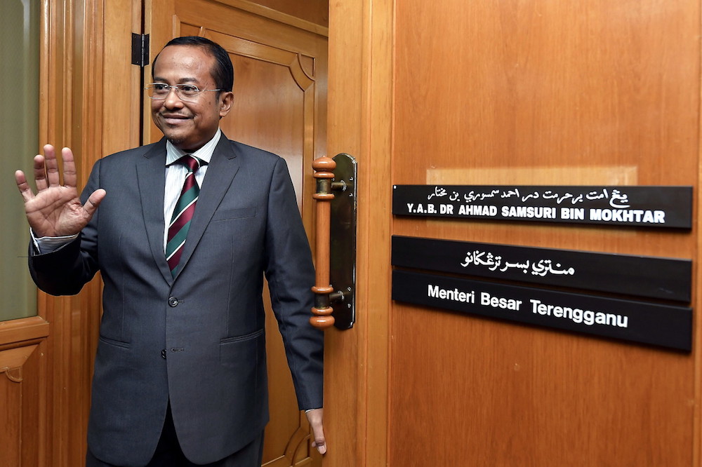 Ahmad Samsuri Mokhtar walks into his office on his first day as Terengganu mentri besar in Wisma Darul Iman in Kuala Terengganu May 14, 2018. u00e2u20acu201d Bernama pic