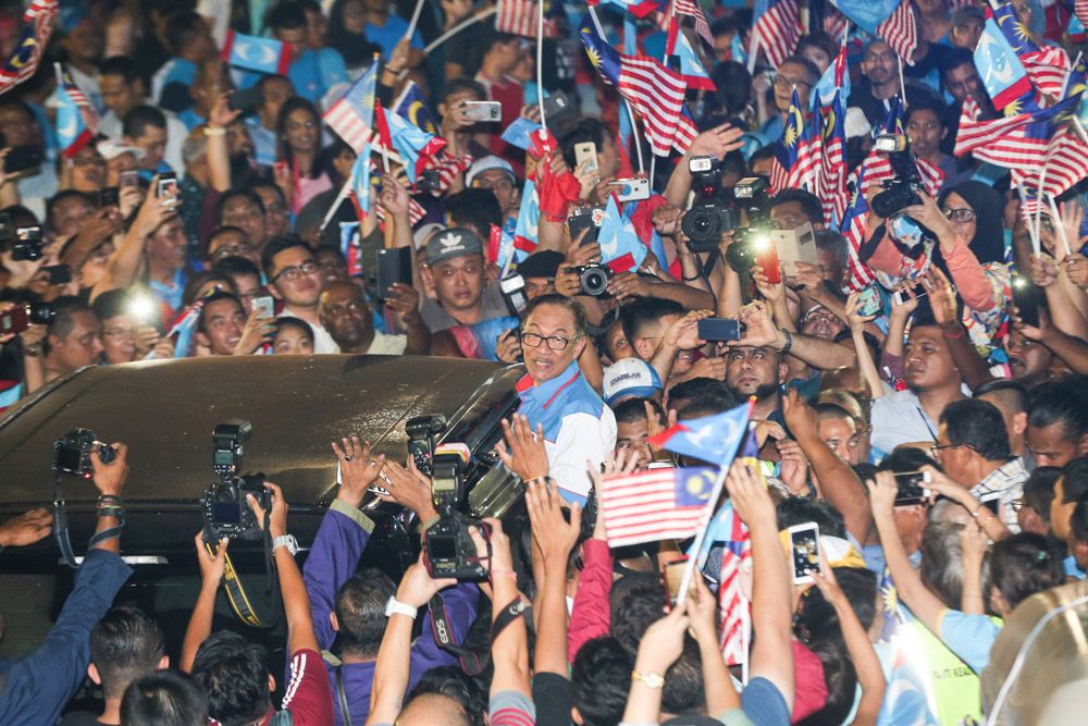 Pakatan Harapan supporters gather in Padang Timur to see Anwar Ibrahim in public after he was released from the prison. — Picture by Ahmad Zamzahuri