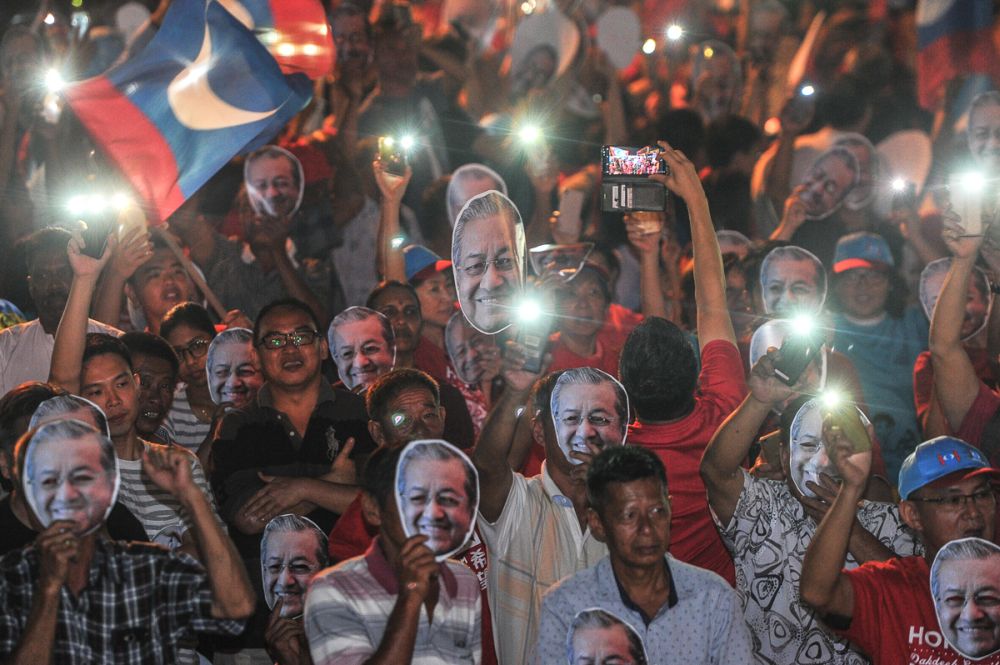 Attendees don Tun Dr Mahathir Mohamad masks during the Ceramah Kebangkitan Rakyat in Ayer Hitam May 5, 2018. u00e2u20acu2022 Picture by Shafwan Zaidon