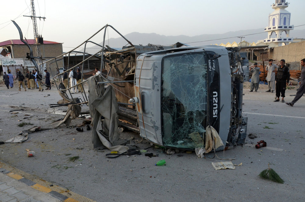 Policemen and locals gather near a destroyed police truck, after three suicide bomb attacks in southwestern city of Quetta, Pakistan April 24, 2018. u00e2u20acu201d Reuters pic