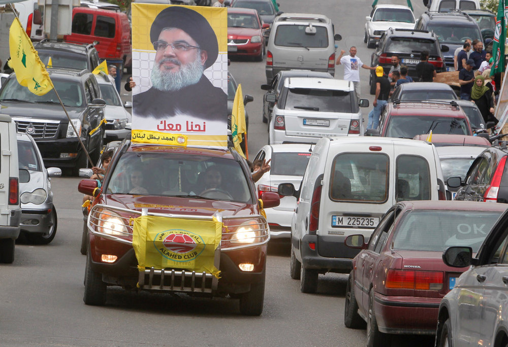 A man gestures as he drives a car with the picture of Hezbollah leader Sayyed Hassan Nasrallah on it, during the parliamentary election day, in Bint Jbeil, southern Lebanon May 6, 2018. u00e2u20acu201d Reuters pic