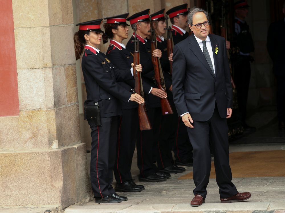 Newly elected Catalonia regional president, Quim Torra, passes in front of Catalan police officers following an investiture debate at the regional parliament in Barcelona May 14, 2018. u00e2u20acu201d Reuters pic
