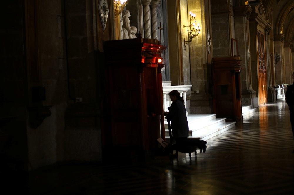 A woman attends a confession inside the Cathedral of Santiago, Chile, May 18, 2018. u00e2u20acu201d AFP pic