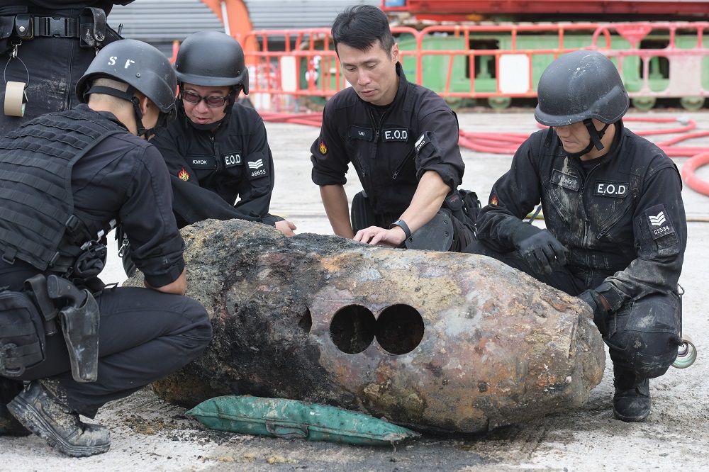 Members of the explosive ordinance disposal unit inspect a defused US-made bomb, dropped during World War II, that was found inside a construction site in the Wan Chai district of Hong Kong May 11, 2018. u00e2u20acu2022 AFP pic
