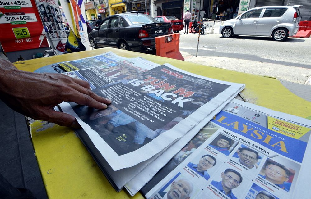 A man reads the newspaper at a shop in Lebuh Ampang, Kuala Lumpur May 10, 2018. u00e2u20acu2022 Picture by Ham Abu Bakar