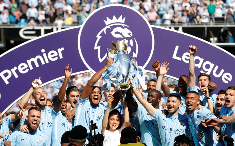 Manchester Cityu00e2u20acu2122s Vincent Kompany and team mates celebrate with the trophy after winning the Premier League title after their match against Huddersfield Town at Etihad Stadium, Manchester May 6, 2018. u00e2u20acu201d Picture by Action Images via Reuters 