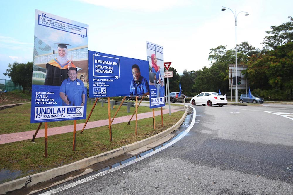 The poster campaign for Tengku Adnan Mansor is seen beside a road in Putrajaya May 4, 2018. u00e2u20acu201d Picture by Azinuddin Ghazali 