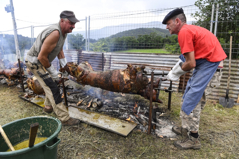 Two men carry a roast pig during the first Sausage World Cup in Vanosc, southern France, June 9, 2018. u00e2u20acu201d AFP pic