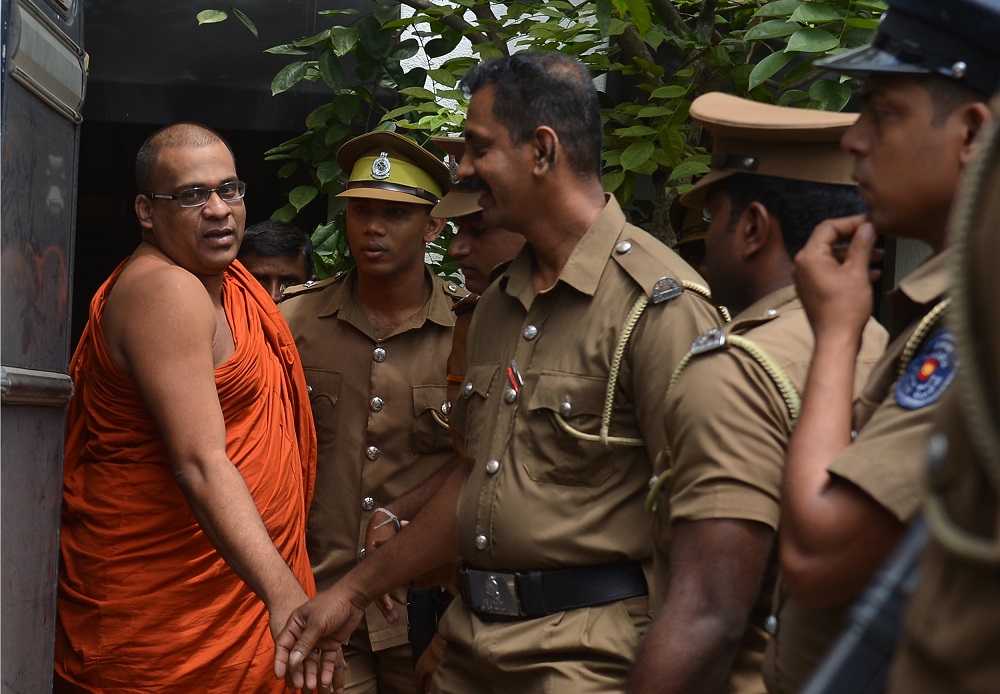 Sri Lankan guards escort firebrand Buddhist monk Galagodaatte Gnanasara after he was sentenced to six months in jail by a magistrate in Homagama June 14, 2018. u00e2u20acu201d AFP pic