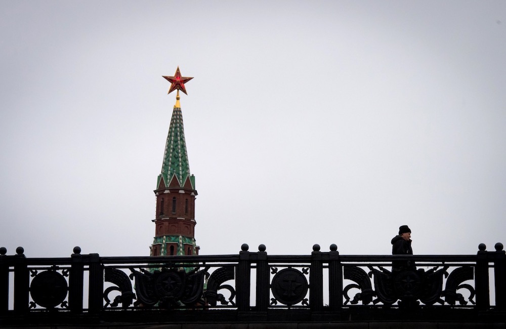 A man walks on a bridge past the Kremlin's Spasskaya (Saviour) Tower in central Moscow January 3, 2018. u00e2u20acu201d AFP pic