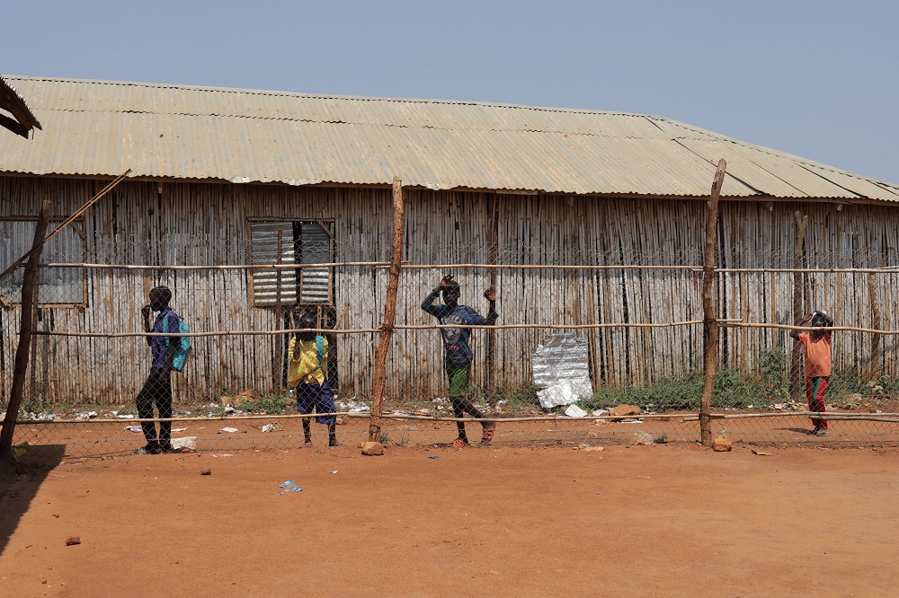Children walk past a school in a Protection of Civilians (PoC) camp on the outskirts of Juba, South Sudan March 23, 2018. u00e2u20acu201d Picture by Thomas Reuters Foundation