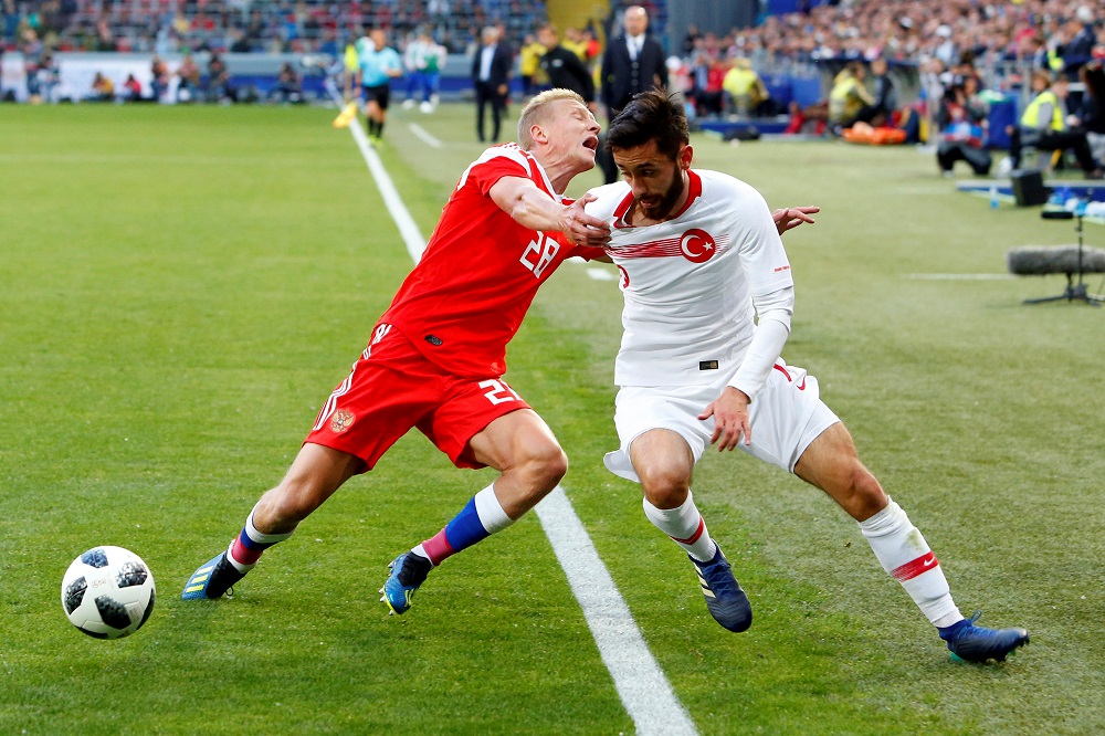 Russiau00e2u20acu2122s Igor Smolnikov in action with Turkeyu00e2u20acu2122s Yunus Malli during the World Cup friendly in Moscow June 5, 2018. u00e2u20acu201d Reuters pic