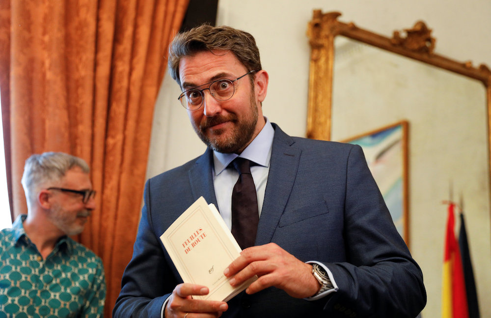Spainu00e2u20acu2122s new Culture Minister Maxim Huerta holds a copy of the book u00e2u20acu02dcFeuilles de Routeu00e2u20acu2122 after receiving the ministerial briefcase from outgoing minister Inigo Mendez de Vigo at the culture ministry in Madrid June 7, 2018. u00e2u20acu201d Reuters pic