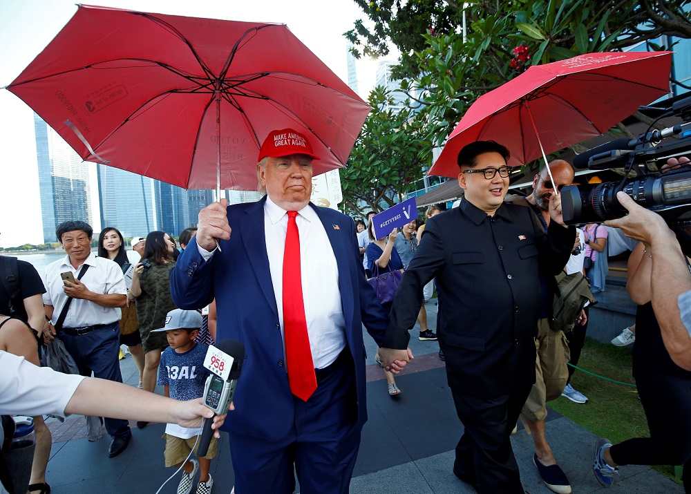 Howard, an Australian-Chinese impersonating North Korean leader Kim Jong-un, and Dennis Alan, impersonating US President Donald Trump, meet at Merlion Park in Singapore June 8, 2018. u00e2u20acu201d Reuters pic