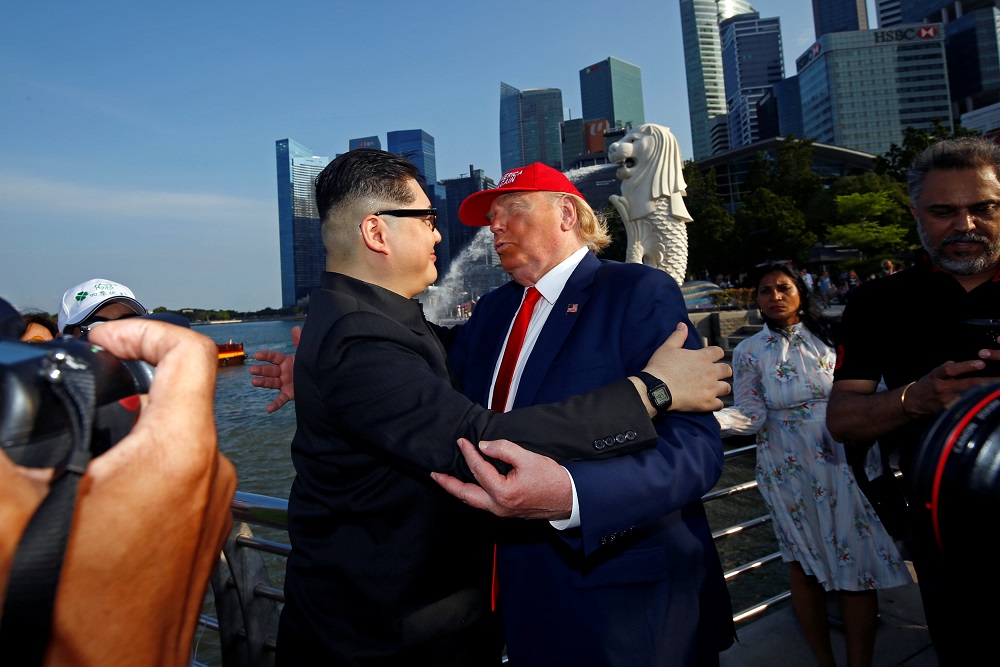 Howard, an Australian-Chinese impersonating North Korean leader Kim Jong-un, and Dennis Alan, impersonating US President Donald Trump, meet at Merlion Park in Singapore June 8, 2018. 