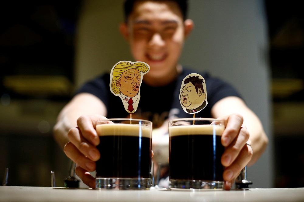 A bartender presents a pair of Donald Trump and Kim Jong-un cocktails called The Bromance at Hopheads Craft Beer Bar and Bistro in Singapore June 8, 2018.