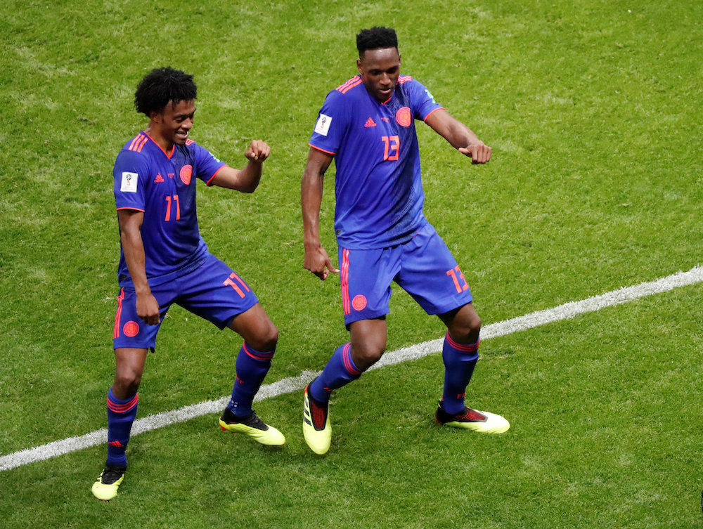 Colombiau00e2u20acu2122s Yerry Mina celebrates scoring their first goal against Poland, with Juan Cuadrado, at the 2018 Fifa World Cup in Kazan June 24, 2018. u00e2u20acu201d Reuters pic