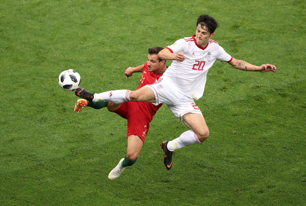 Portugalu00e2u20acu2122s Cedric Soares in action with Iranu00e2u20acu2122s Sardar Azmoun at the 2018 Fifa World Cup in Saransk June 25, 2018. u00e2u20acu201d Reuters pic