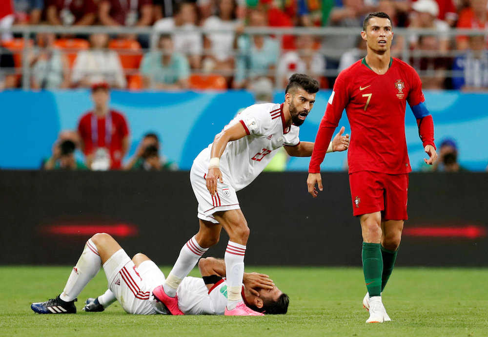 Portugalu00e2u20acu2122s Cristiano Ronaldo and Iranu00e2u20acu2122s Ramin Rezaeian and Morteza Pouraliganji react before a red card decision was referred to VAR at the 2018 Fifa World Cup in Saransk June 25, 2018. u00e2u20acu201d Reuters pic