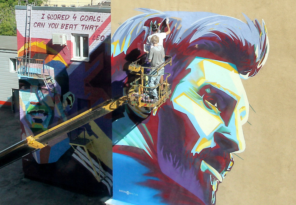 A mural of Argentinau00e2u20acu2122s Lionel Messi is painted next to another of Portugalu00e2u20acu2122s Cristiano Ronaldo in Kazan June 29, 2018. u00e2u20acu201d Reuters pic