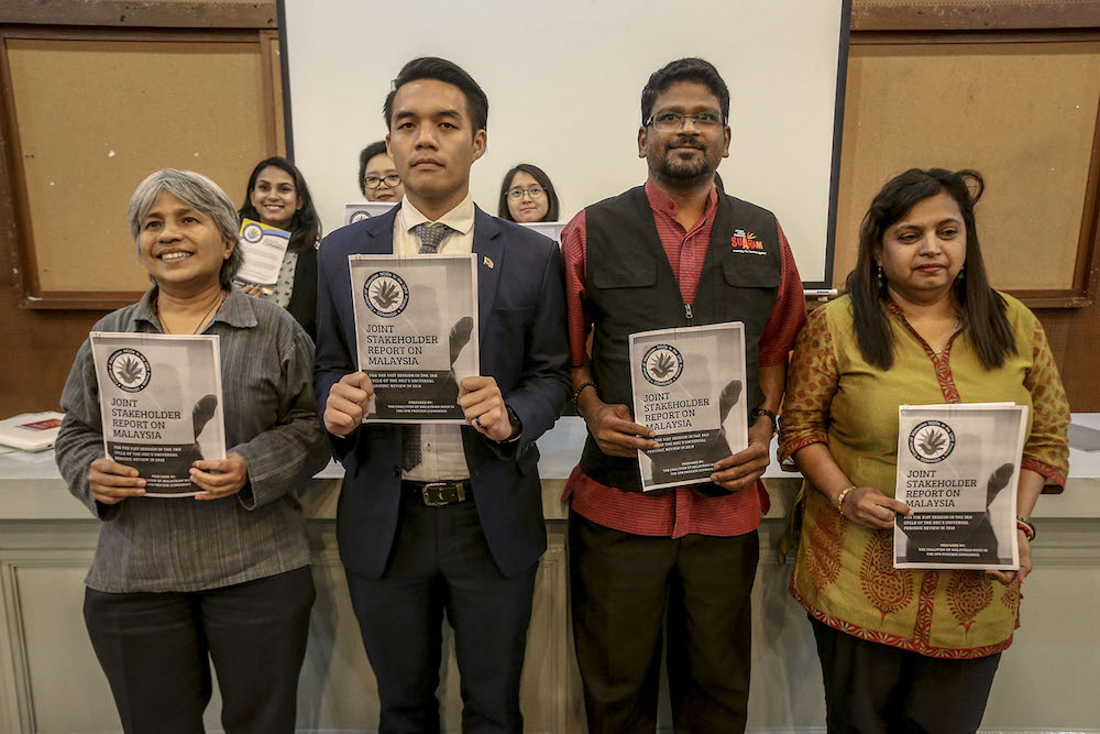 Angela M. Kuga Thas, Rizal Rozhan, Sevan Doraisamy and Bina Ramanand hold copies of the Comango UPR Stakeholder Report in Kuala Lumpur June 7, 2018. u00e2u20acu201d Picture by Hari Anggara