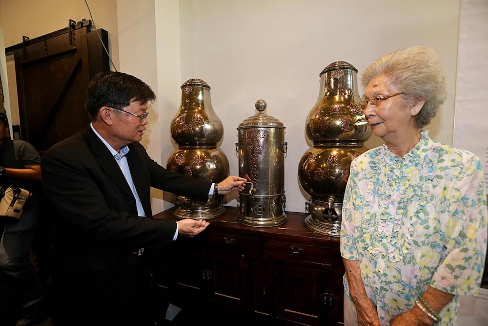 Penang Chief Minister Chow Kon Yeow speaks to retired herbal drinks shop owner Chan So Han during the launch of the George Town Unesco World Heritage Site 10th anniversary exhibition in George Town June 14, 2018. u00e2u20acu201d Picture by Sayuti Zainudin