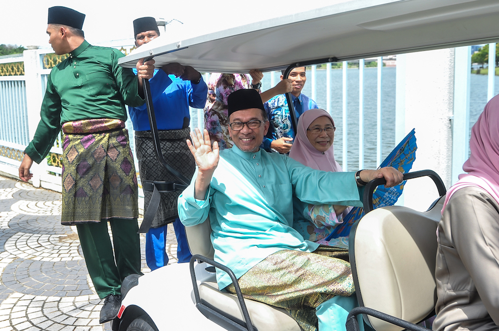 Datuk Seri Anwar Ibrahim and Datuk Seri Dr Wan Azizah Wan Ismail attend the prime ministeru00e2u20acu2122s Aidilfitri open house in Putrajaya June 15, 2018. u00e2u20acu201d Picture by Shafwan Zaidon