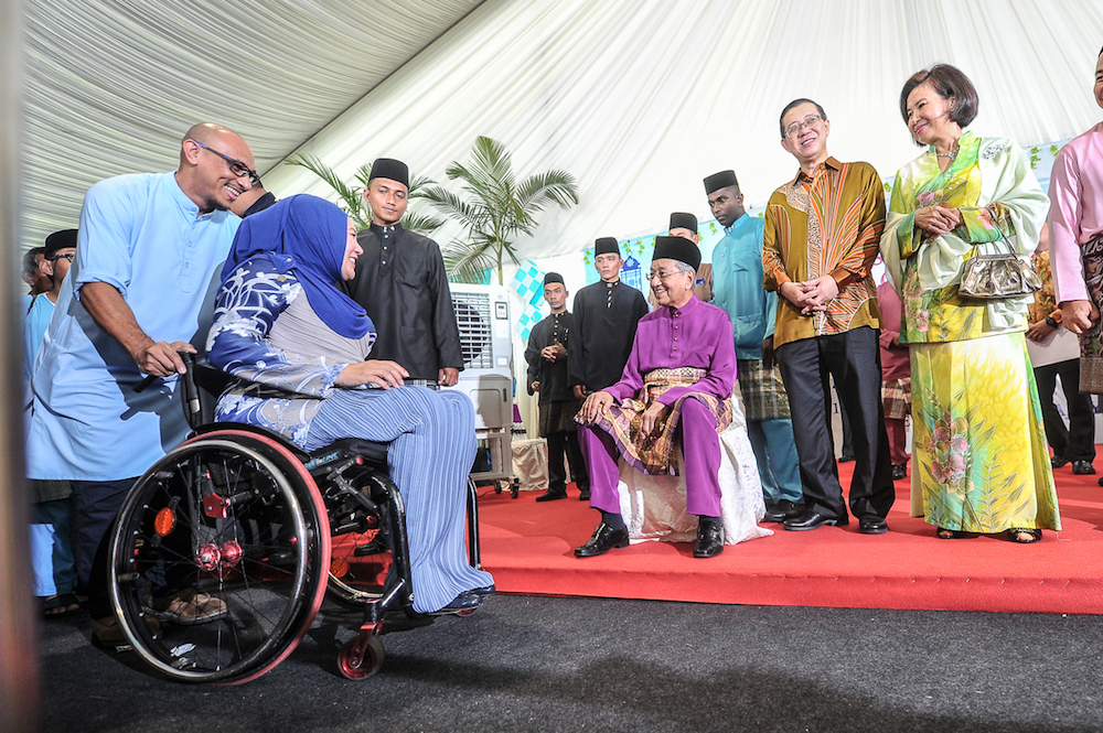 Tun Dr Mahathir Mohamad greets members of the public during the prime ministeru00e2u20acu2122s Aidilfitri open house in Putrajaya June 15, 2018. u00e2u20acu201d Picture by Shafwan Zaidon