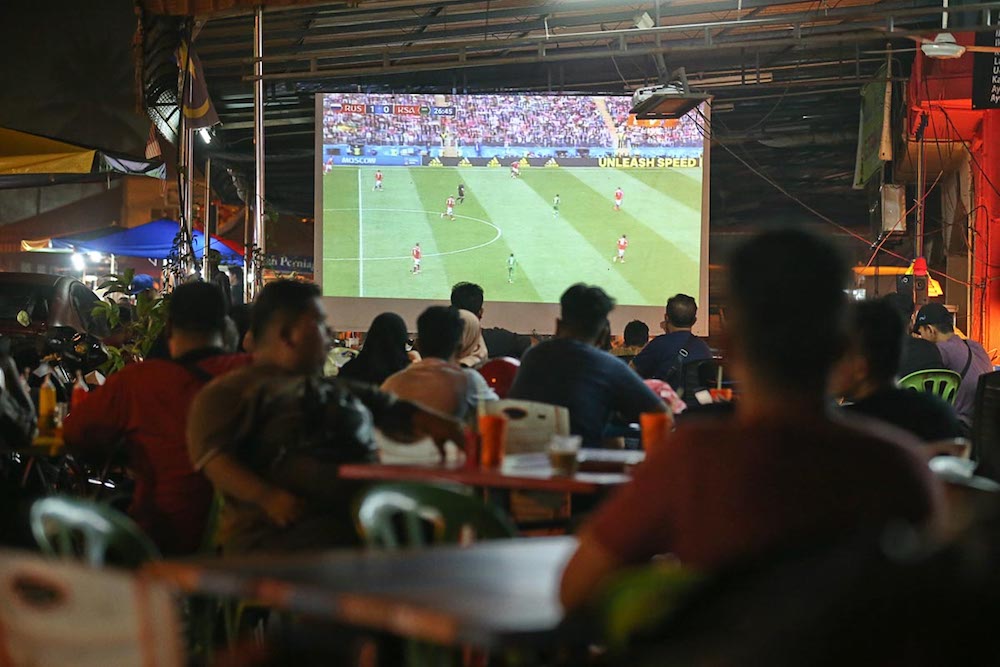 People watch the first game of the 2018 Fifa World Cup between Russia and Saudi Arabia at Arena Square in Kuala Kangsar June 14, 2018. u00e2u20acu201d Picture by Sayuti Zainudin