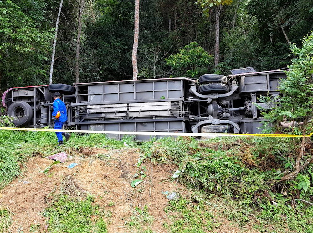 The express bus rests on its side after crashing along KM24 of the Gerik-Jeli highway. — Picture courtesy of Fire and Rescue Department