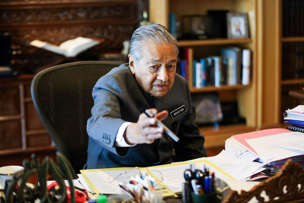 Tun Dr Mahathir Mohamad reaches for a Pilot pen during an exclusive interview with Malay Mail at the Perdana Leadership Foundation in Putrajaya June 21, 2018. u00e2u20acu2022 Picture by Ahmad Zamzahuri