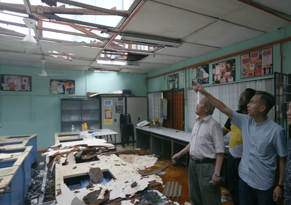 Lembah Pantai MP Fahmi Fadzil, Education Ministry sec-gen Datuk Seri Gazali Abas and Wan Saiful Wan Jan inspect the damaged SMK Seri Pantai roof after it was hit by storm in Kuala Lumpur June 23, 2018. u00e2u20acu201d Picture by Razak Ghazali