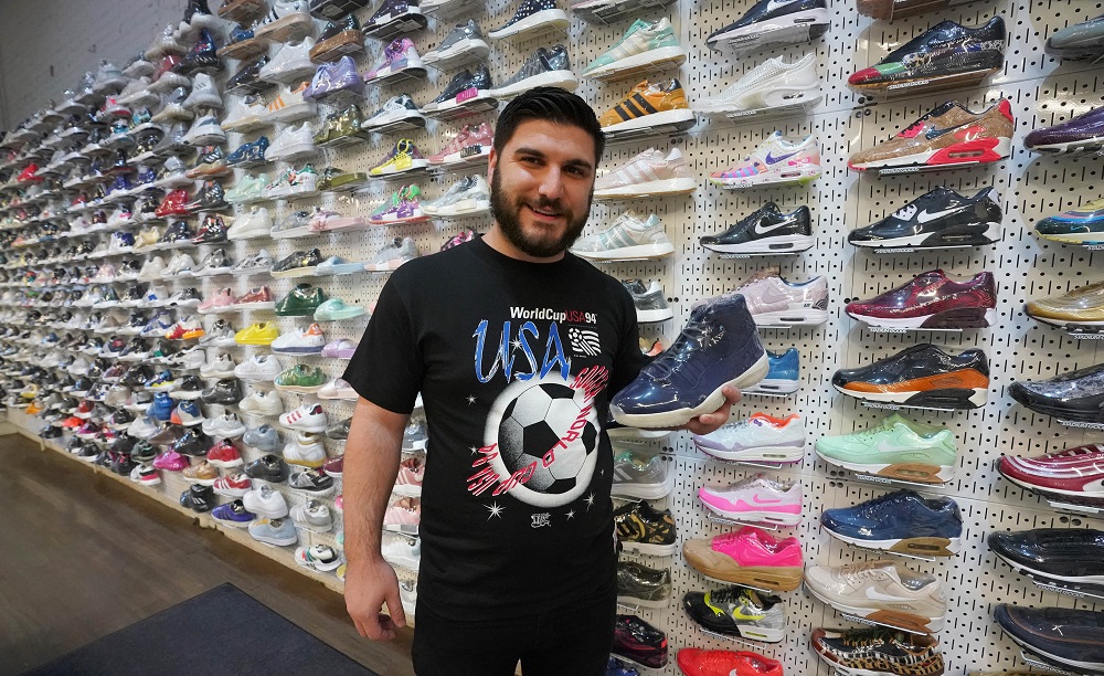 Buyer/reseller Matt Troisi holds an Air Jordan 11 Jeter sneaker at Stadium Goods. u00e2u20acu201d AFP pic