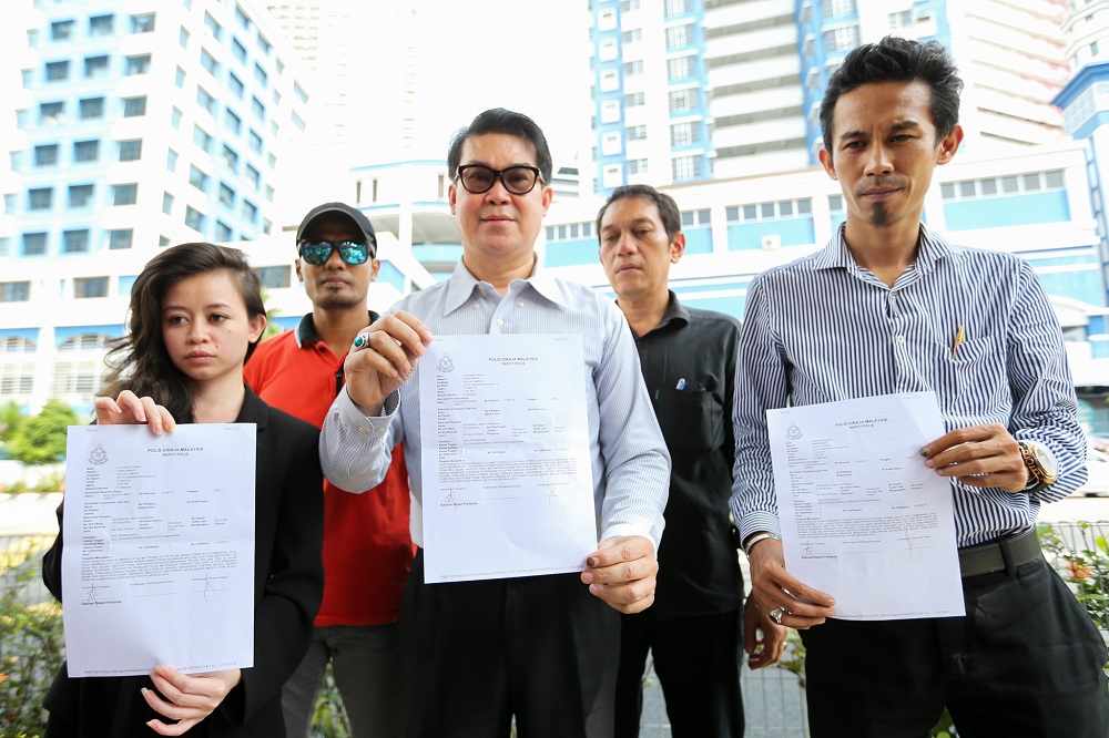 KLCC Umno branch chief Datuk Seri Dzulkarnain Taib (centre) and other Umno members speak to reporters after lodging a police report against Finance Minister Lim Guan Eng in Kuala Lumpur June 27, 2018. u00e2u20acu201d Picture by Ahmad Zamzahuri