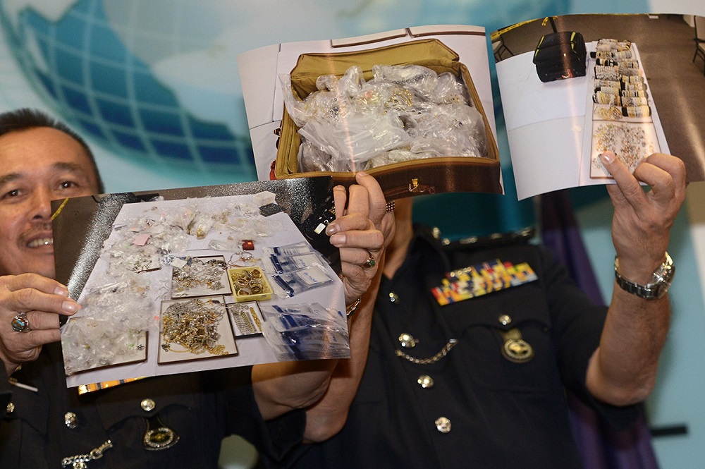Police officers display photos of some of the valuables seized in the raids conducted on Datuk Seri Najib Razaku00e2u20acu2122s properties, in Kuala Lumpur June 27, 2018. u00e2u20acu201d Picture by Mukhriz Hazim