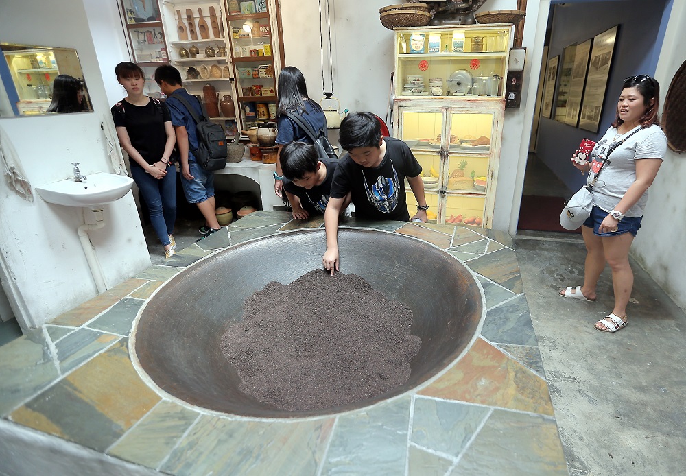 Visitors look at the collection of artefacts at the Ho Yan Hor Museum.