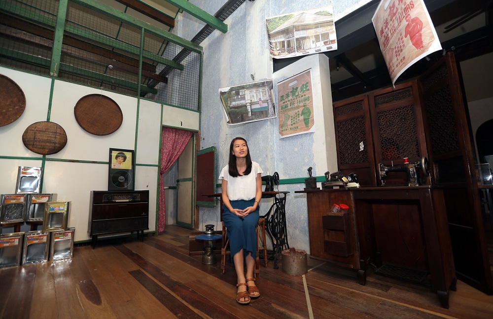 Museum curator Lim Yi Wen showing the artefacts displayed at the 22 Hale Street gallery in Ipoh.