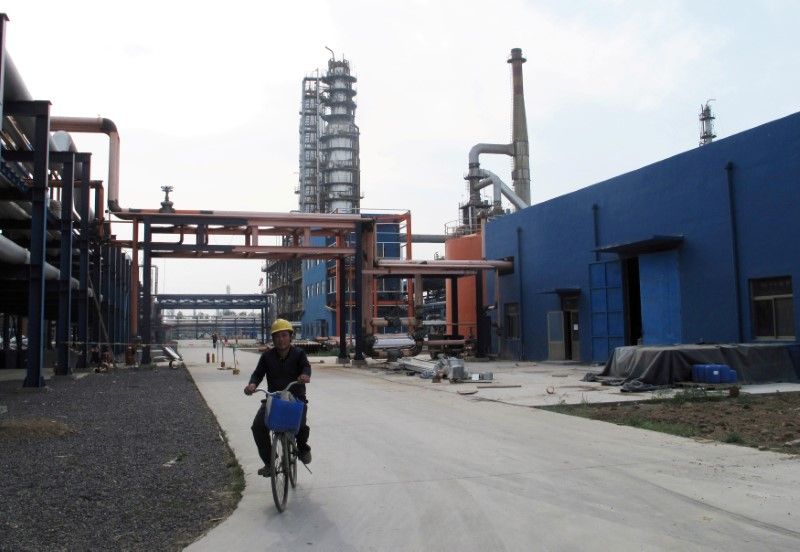 File photo of an employee riding a bike on a road near refinery plants of Chambroad Petrochemicals, in Boxing, Shandong Province, China May 10, 2016. u00e2u20acu2022 Reuters pic