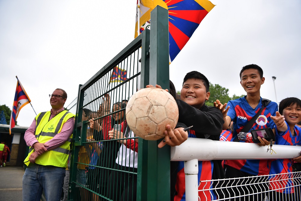 A young Tibet fan holds a football in the hope a player will sign it after the full-time whistle of the Confederation of Independent Football Association 2018 World Football Cup match, London, May 31, 2018. u00e2u20acu201d AFP pic